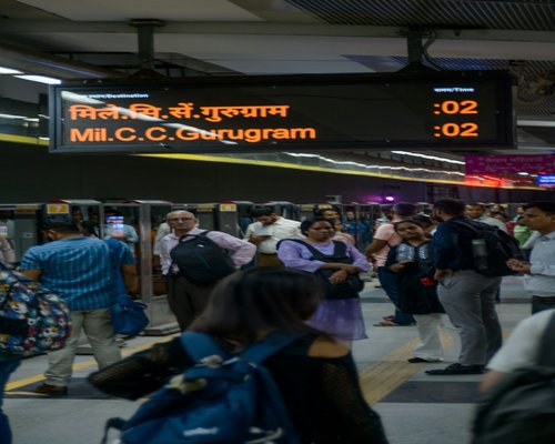 People walking near a metro station in an Indian city